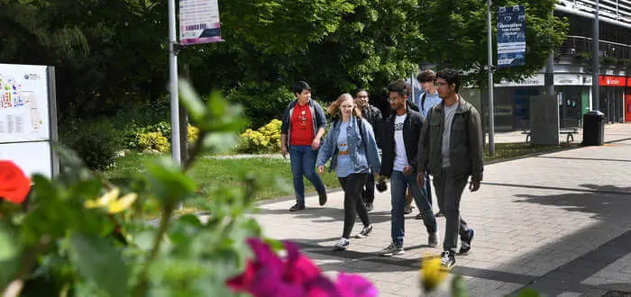 students walking on campus concourse