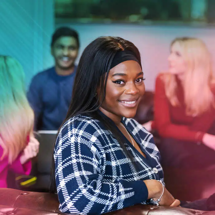 woman sitting with friends smiling into the camera