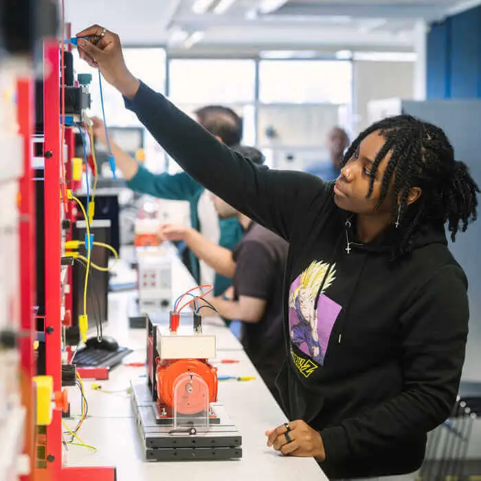 Students in a lab working on electrical engineering projects