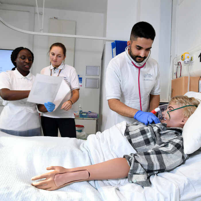 brunel-students-attending-to-a-dummy-patient-in-a-clinical-room