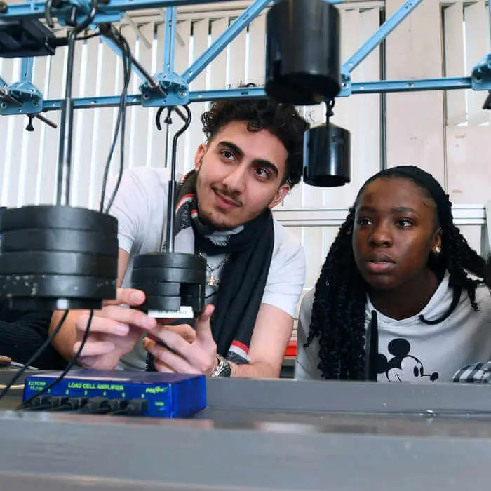 Brunel students in the civil engineering lab performing an experiment