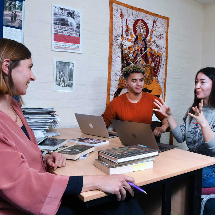 Female and male student talking to a female academic