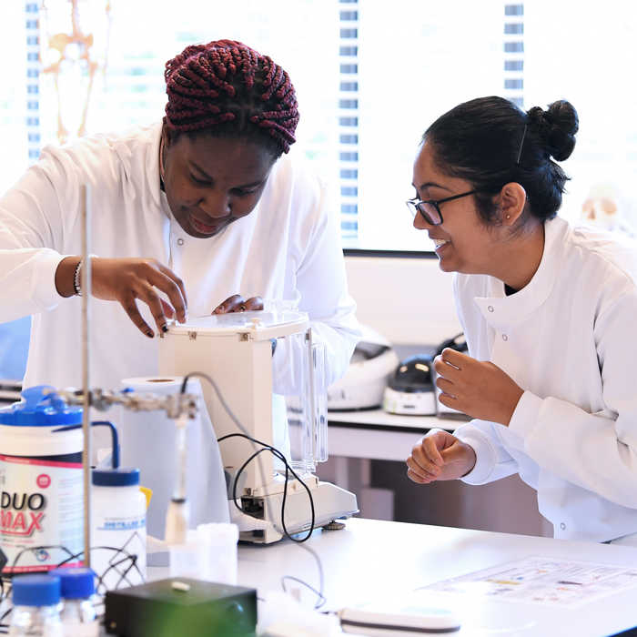Two female students conducting an experiment