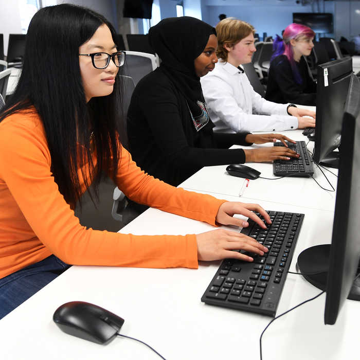 Male and female students working on a computer in a computer lab