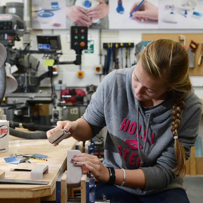 Female student working in the wood work design lab
