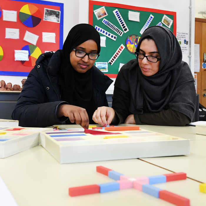 Two female students working together on a puzzle
