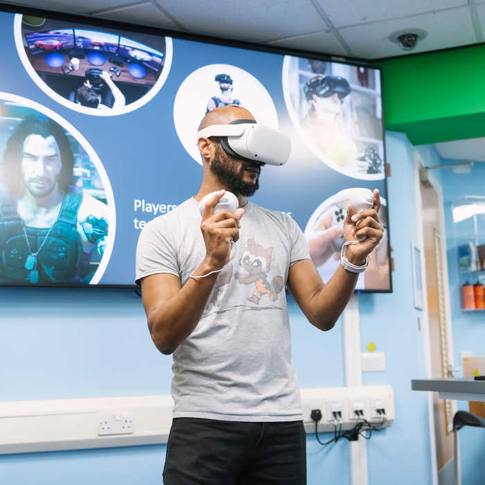 Male games design playing on a virtual reality gaming set