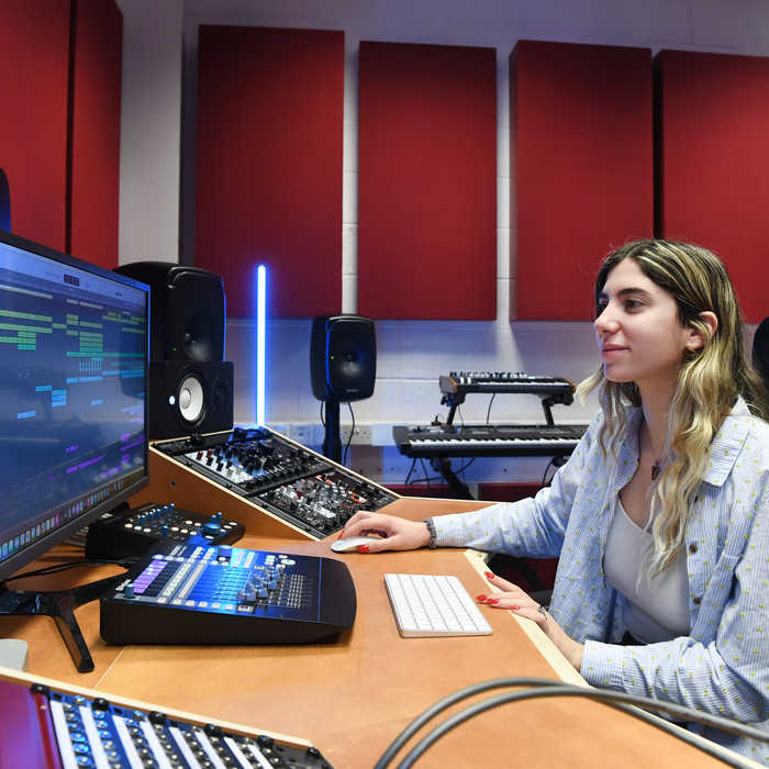 Music student using the computer in the sound room