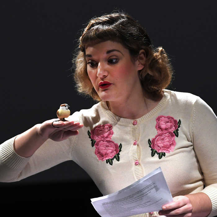 Theatre student performing on stage holding a script